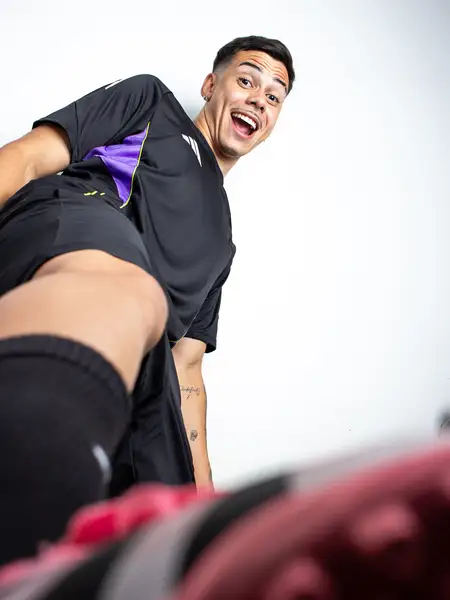 Dudu Footz smiling at the camera from a low angle, in a relaxed pose